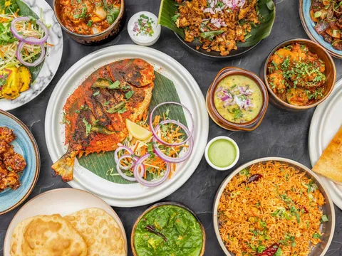 Overhead spread of South Indian dishes, breads and chutneys at Sangamam