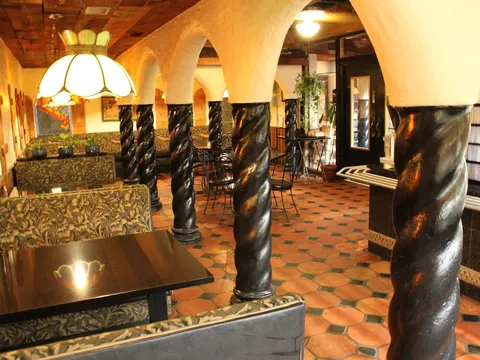 Dining room with carved black columns and arches at Kalachandji's in Dallas
