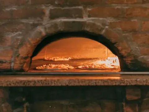 Pizza baking in the wood-fired oven at Pizzeria Bianco