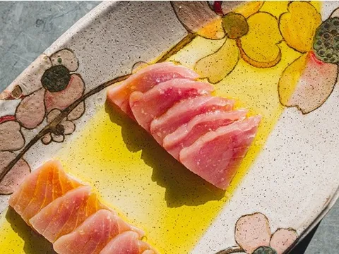 Sliced raw fish crudo with olive oil on a floral-patterned plate at Oberlin in Providence