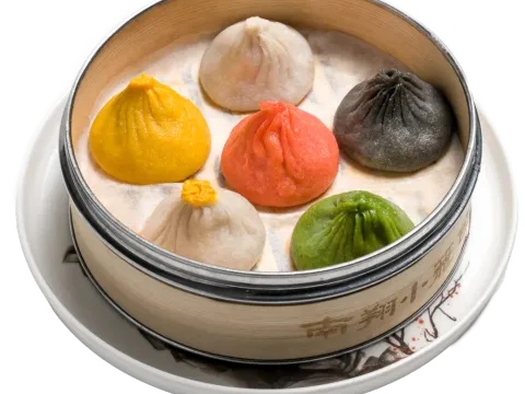 Steamer of multicoloured soup dumplings at Nan Xiang