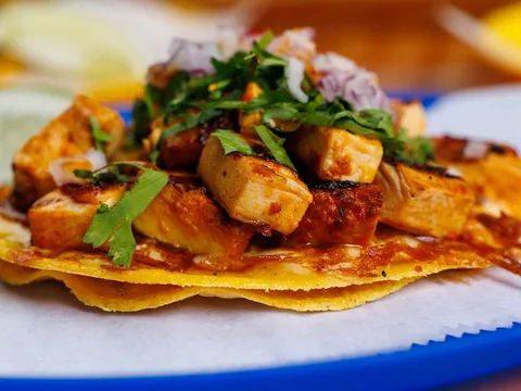 Del Trompo achiote pork taco with pineapple, cilantro and red onion on a crispy cheese-crusted tortilla at Mestiza