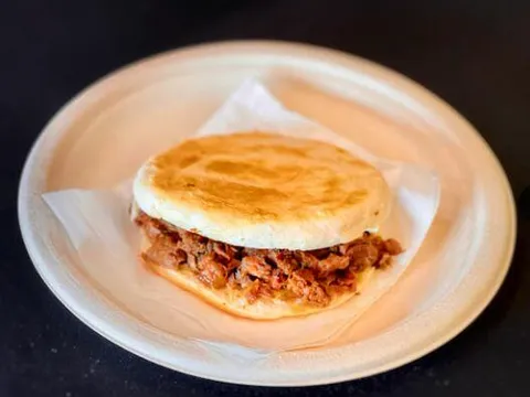 Rou jia mo — stewed pork in a griddled flatbread bun on a plate at Xi'an Gourmet House