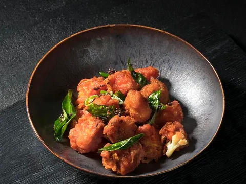 Rasika's cauliflower bezule served in a dark bowl