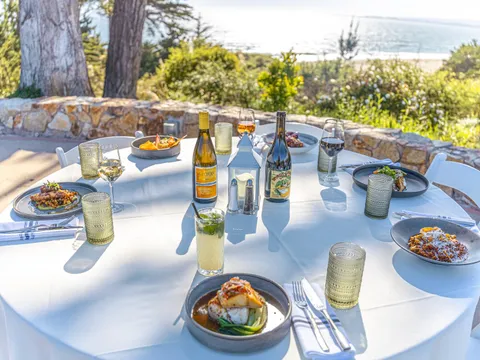 Ocean-view patio table set for dinner at Sanderlings Restaurant