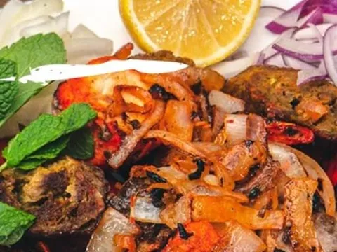 A platter of grilled tandoori meats and vegetables from City of Spice.