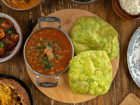 Overhead spread of curries, bhature and rice at Delhi Dhaba