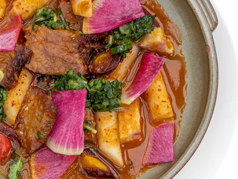 Braised short rib and rice cakes with watermelon radish in a rich red sauce at Han Oak in Portland