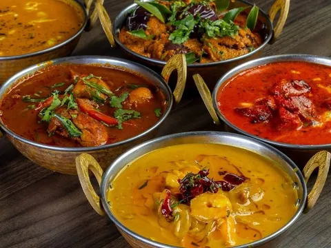 Curries and dal in copper karahi bowls at The Park Indian Restaurant