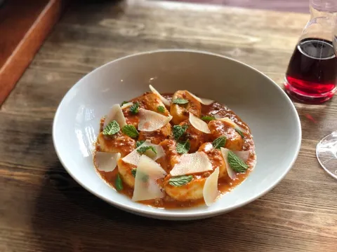Ricotta gnocchi in tomato sauce with shaved parmesan and mint at FIG