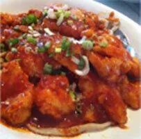 Sauced chicken dish garnished with scallions at Chiang's Gourmet