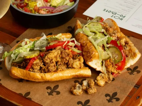 Fried oyster po-boy on Leidenheimer French bread dressed with lettuce, tomato and pickle at Mahony's Po-Boys