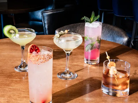 A spread of craft cocktails on a table at The Republic on Grand