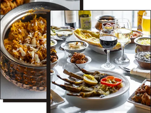Biryani, wine and assorted Indian dishes plated at India Bistro in Ballard