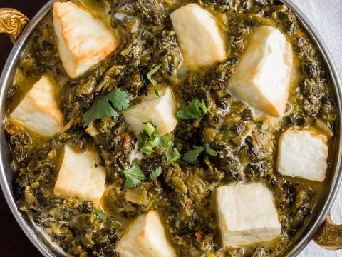 Saag paneer served in a copper karahi at Bhatti Himalayan Grill