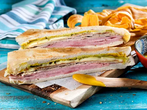 Cuban sandwich with ham, roast pork and Swiss cheese, served with plantain chips, at La Carreta