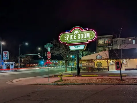 Spice Room Bluebird District exterior and illuminated sign at night