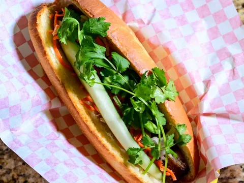 Bánh mì sandwich with pork, pickled carrots and cilantro on a paper-lined tray at Da Vang Restaurant in Phoenix