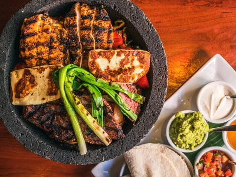 Grilled meats and vegetables with tortillas and salsas at El Vez Philadelphia