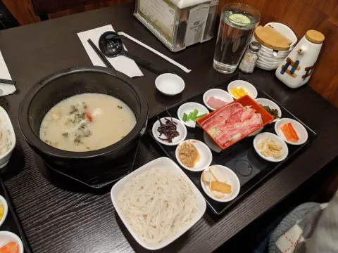 Crossing-the-bridge rice noodle set with hot broth, rice noodles and side toppings at Yun Nan Crossing Bridge Noodle in Columbus