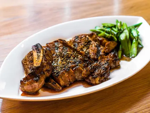 Grilled dish with scallions on an oval plate at RedFarm