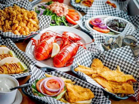 Spread of lobster, fried clams, fish and chips and seafood rolls at Newick's Lobster House