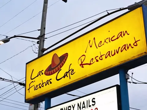 Yellow roadside sign for Las Fiestas Cafe Mexican Restaurant